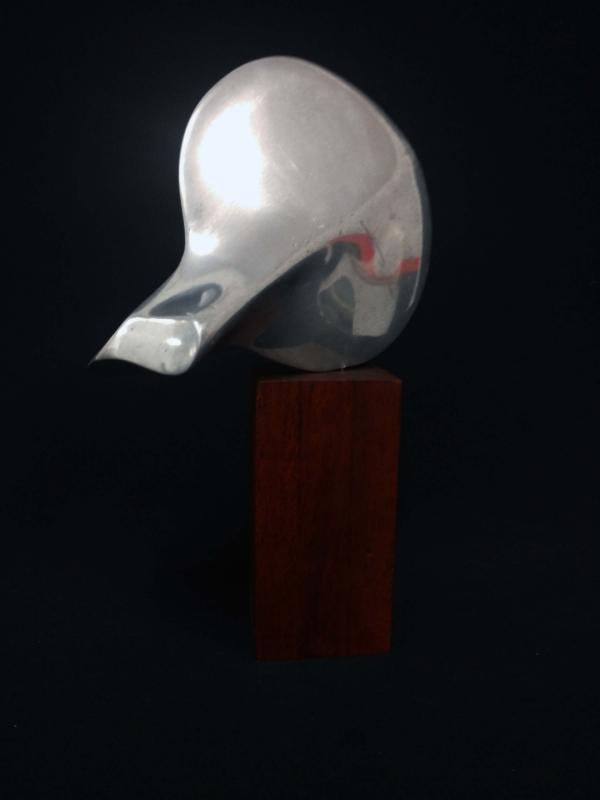 Untitled - Cast Aluminum on wooden base.. 9" x 6.5" x 3.5' 1974 collection of the artist.